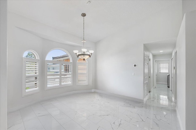 unfurnished dining area featuring a textured ceiling and a notable chandelier