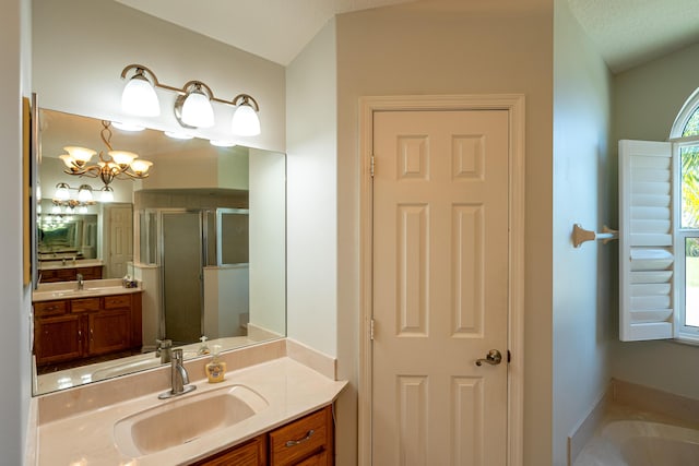 bathroom featuring separate shower and tub, vanity, a textured ceiling, and a notable chandelier