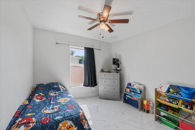 bedroom with ceiling fan and a textured ceiling