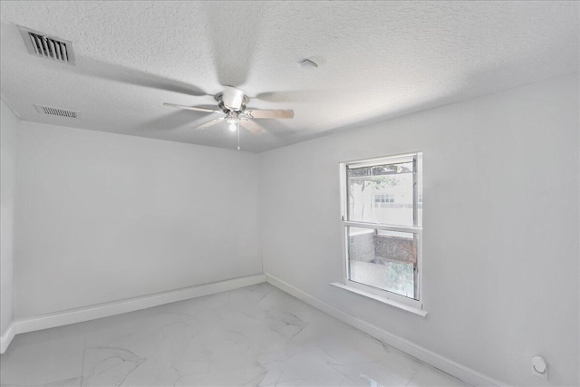 unfurnished room featuring plenty of natural light, ceiling fan, and a textured ceiling