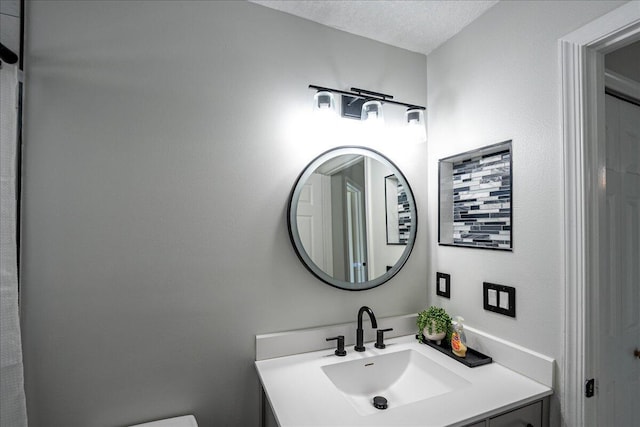 bathroom featuring vanity and a textured ceiling