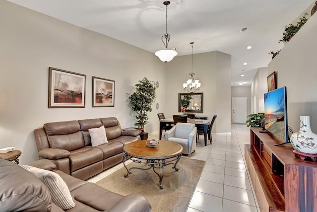 tiled living room featuring an inviting chandelier