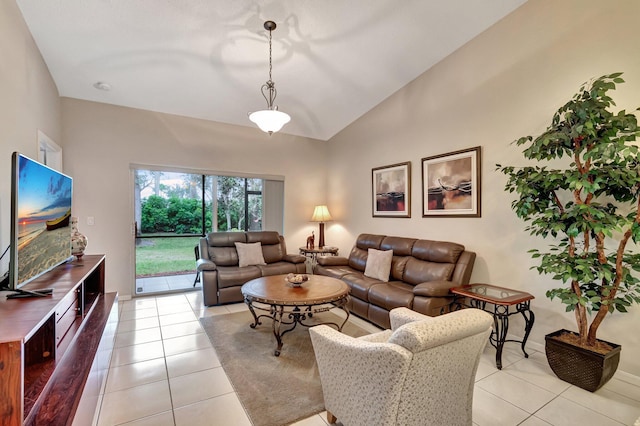 living room featuring vaulted ceiling and light tile patterned flooring