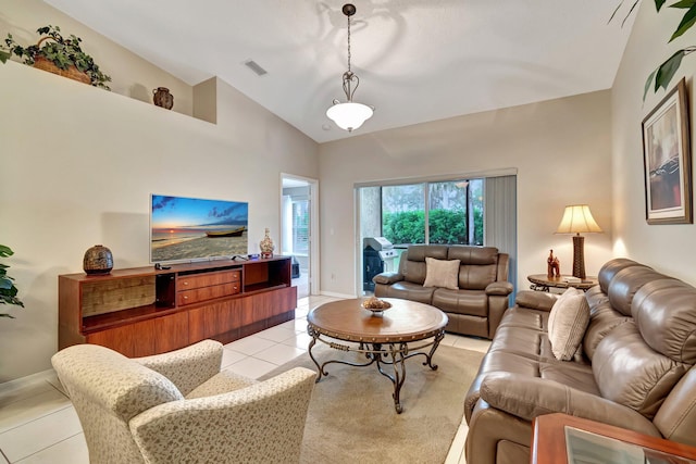 living room with vaulted ceiling and light tile patterned floors