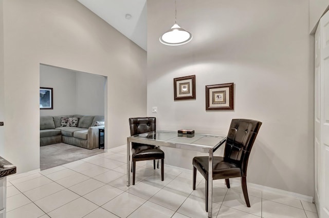 dining room featuring light tile patterned floors and high vaulted ceiling