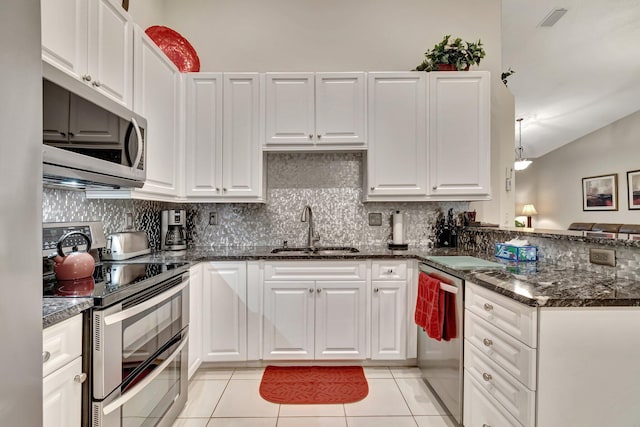 kitchen featuring sink, light tile patterned floors, white cabinets, and appliances with stainless steel finishes