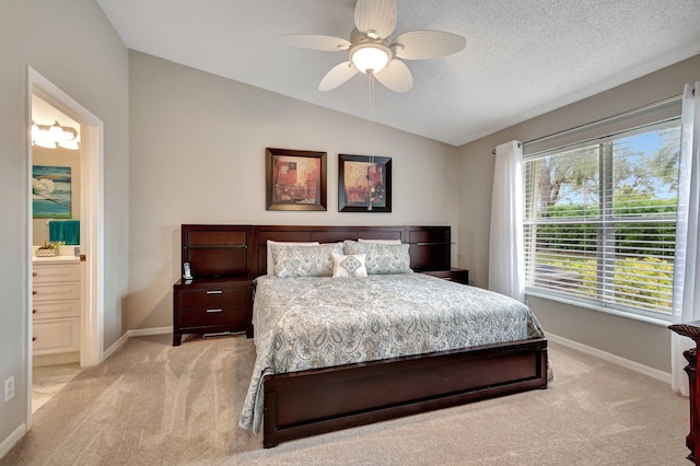 bedroom with lofted ceiling, ensuite bath, ceiling fan, a textured ceiling, and light carpet