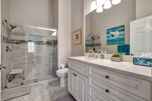 bathroom with a shower with door, vanity, and toilet