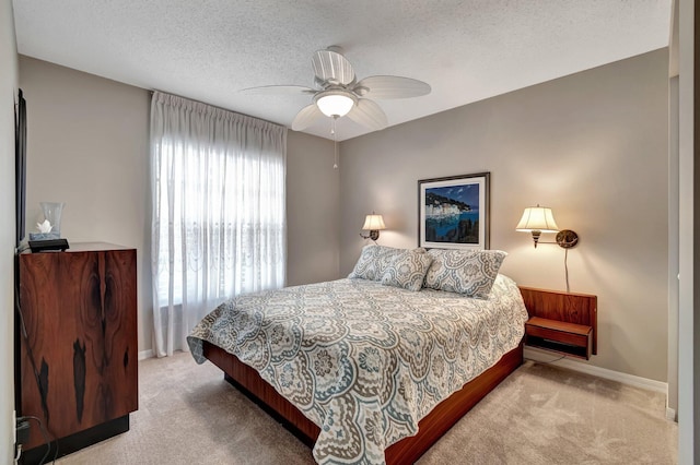 bedroom with light carpet, a textured ceiling, and ceiling fan