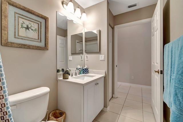 bathroom featuring vanity, tile patterned floors, and toilet