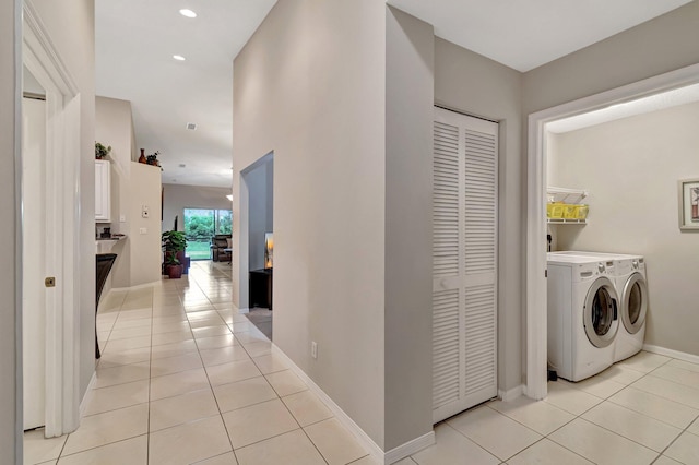 laundry room with light tile patterned floors and washer and dryer