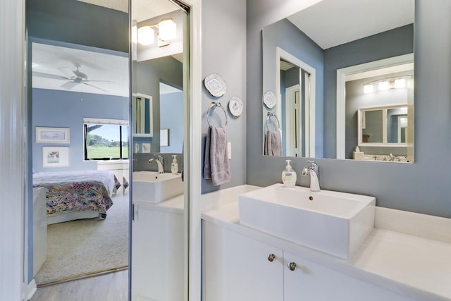 bathroom with ceiling fan, vanity, and wood-type flooring