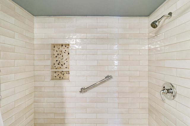 bathroom with a tile shower