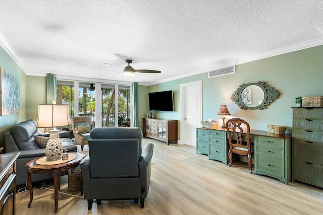 living room with ceiling fan, light hardwood / wood-style flooring, crown molding, and a textured ceiling