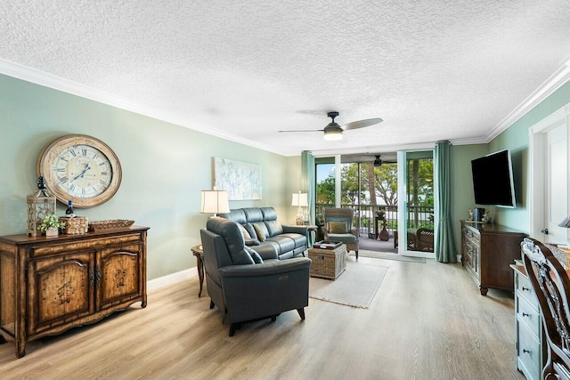 living room featuring light wood-type flooring, expansive windows, a textured ceiling, ceiling fan, and crown molding