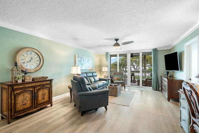 living room with ornamental molding, a textured ceiling, ceiling fan, light hardwood / wood-style flooring, and a wall of windows