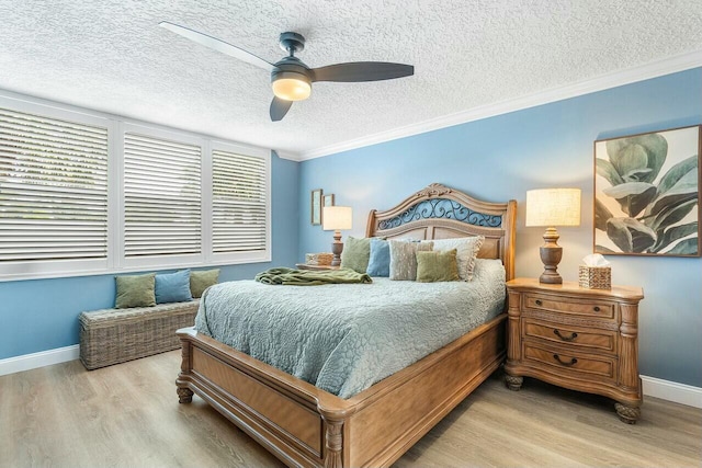 bedroom featuring a textured ceiling, light hardwood / wood-style floors, ceiling fan, and crown molding