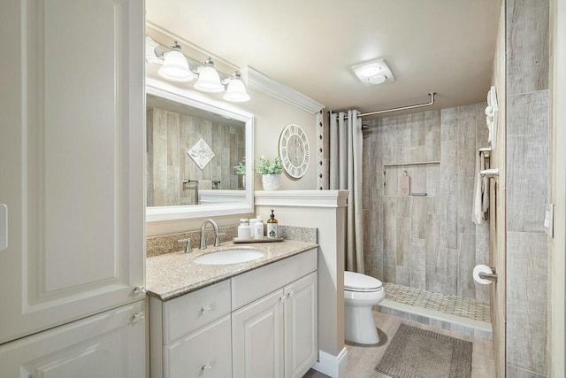 bathroom featuring vanity, toilet, and walk in shower