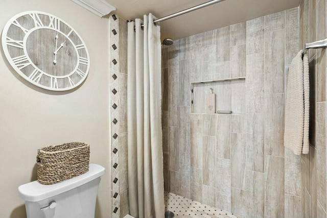 bathroom with a shower with curtain and toilet