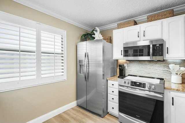 kitchen with decorative backsplash, white cabinetry, a textured ceiling, and appliances with stainless steel finishes