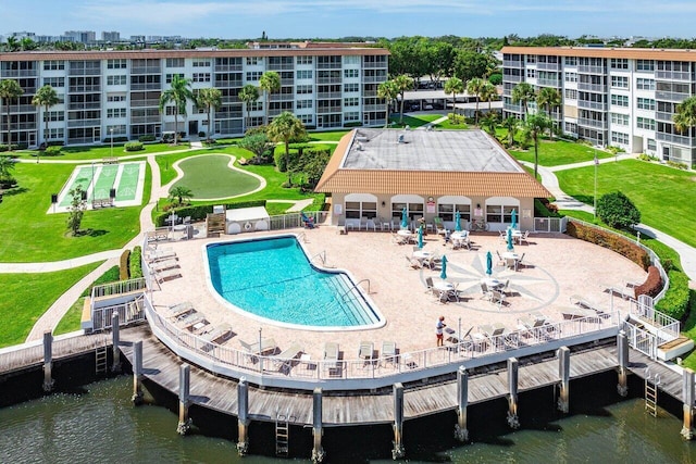 view of pool featuring a water view and a patio area