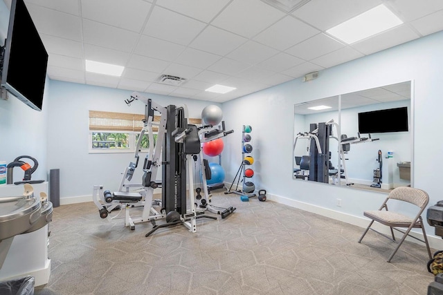 exercise room with a paneled ceiling