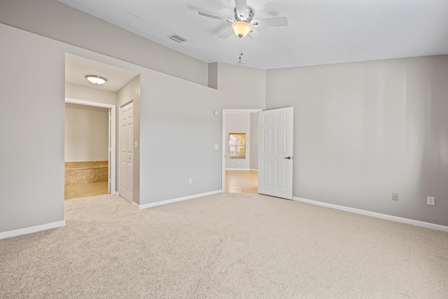 unfurnished bedroom featuring light colored carpet and ceiling fan