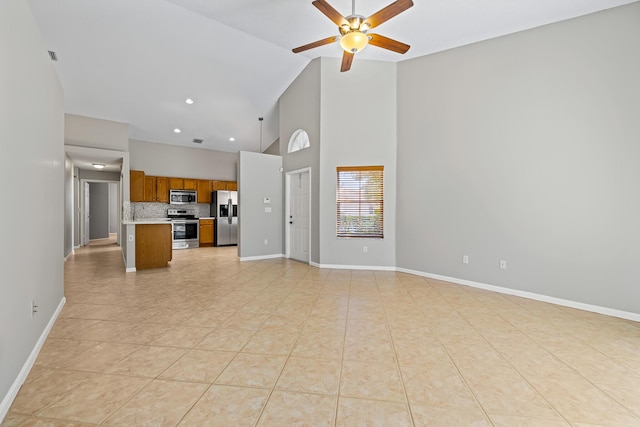 unfurnished living room featuring ceiling fan, high vaulted ceiling, and light tile patterned floors