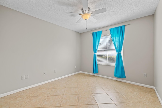 tiled spare room featuring ceiling fan and a textured ceiling