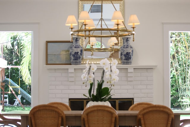 room details featuring a fireplace and an inviting chandelier