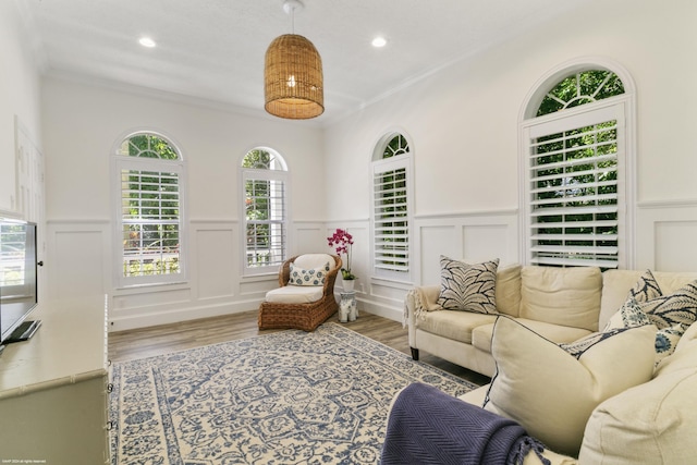 living room with light hardwood / wood-style flooring and crown molding