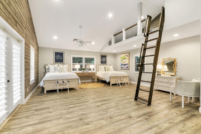 bedroom with ceiling fan, high vaulted ceiling, and light hardwood / wood-style flooring