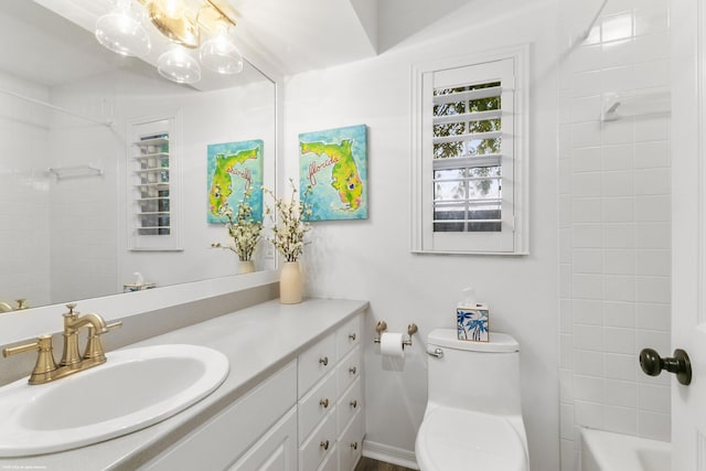 full bathroom with vanity, toilet, and tiled shower / bath combo