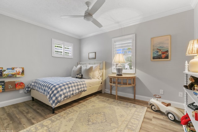 bedroom with hardwood / wood-style flooring, ceiling fan, and multiple windows