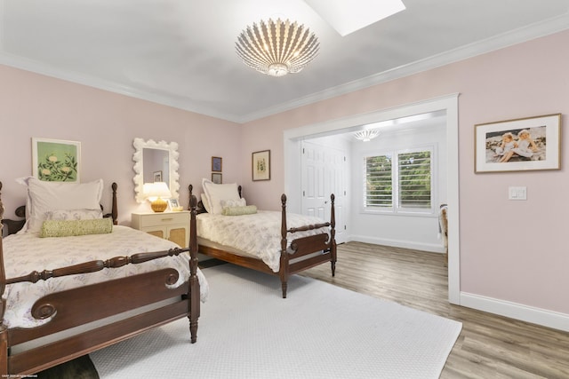 bedroom featuring hardwood / wood-style floors and ornamental molding