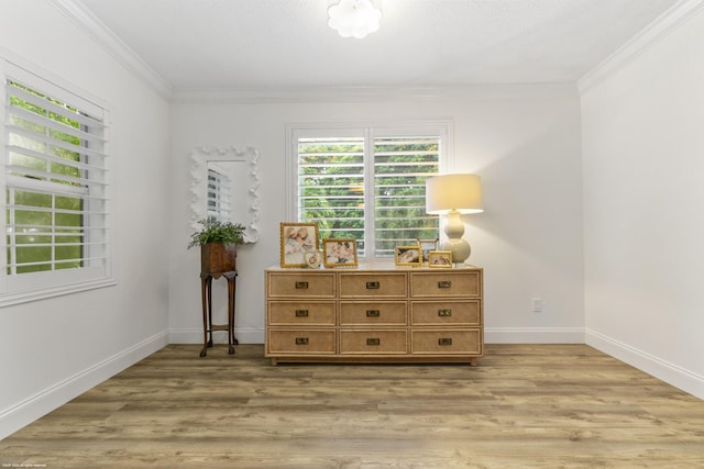 interior space with hardwood / wood-style flooring and crown molding