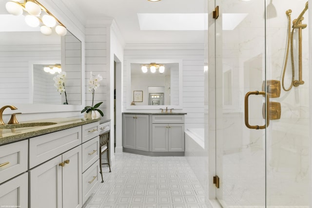 bathroom with vanity, a skylight, and a shower with shower door