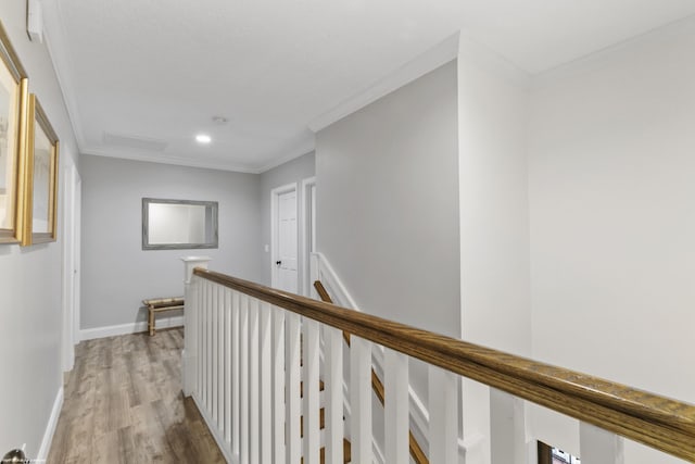 hallway featuring light hardwood / wood-style floors and ornamental molding