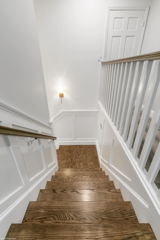 staircase featuring wood-type flooring