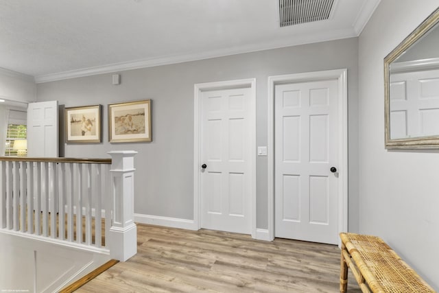 corridor featuring ornamental molding and light hardwood / wood-style flooring