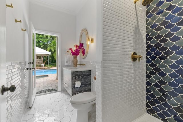 bathroom featuring tile patterned floors, crown molding, and a shower