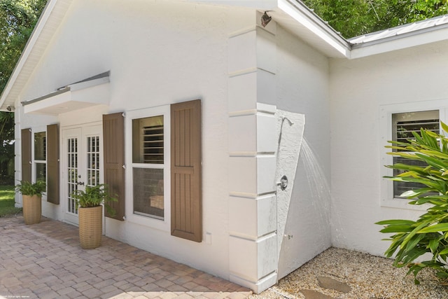 view of side of home with french doors and a patio