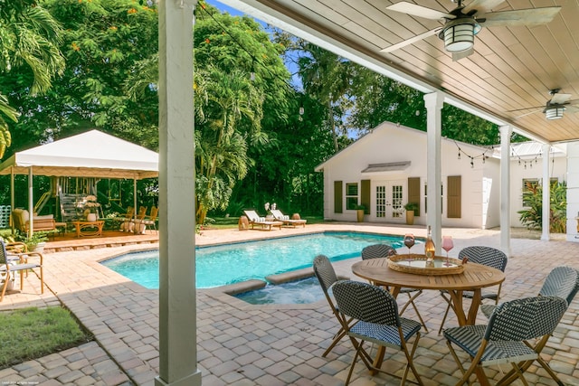 view of pool featuring a gazebo, a patio area, ceiling fan, and french doors