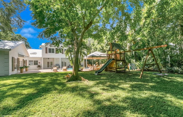 view of yard with a patio and a playground