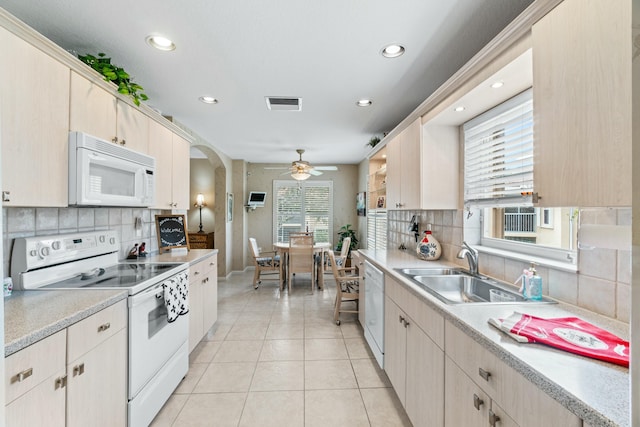 kitchen with decorative backsplash, white appliances, ceiling fan, and sink