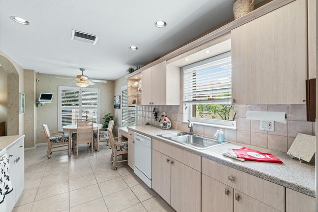 kitchen with dishwasher, ceiling fan, sink, and light brown cabinetry