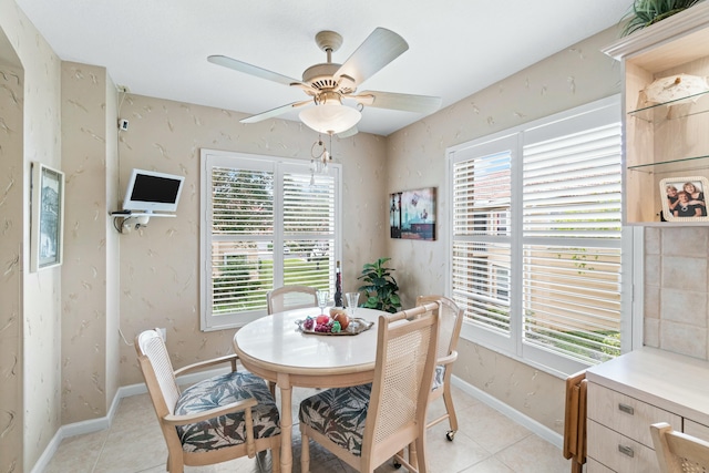 dining area with light tile patterned floors and ceiling fan