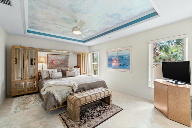 bedroom featuring a tray ceiling, ceiling fan, and crown molding