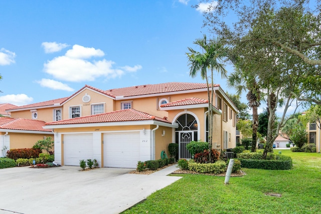 mediterranean / spanish-style house with a front yard and a garage