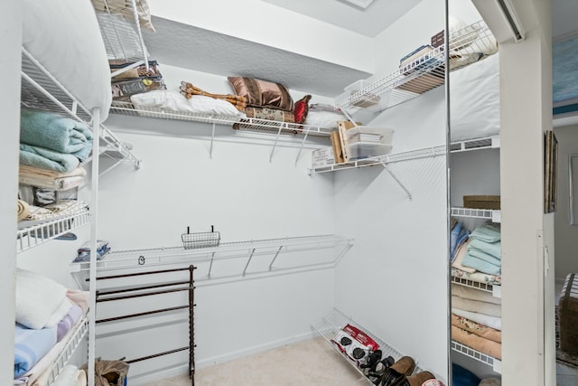 spacious closet with light tile patterned floors